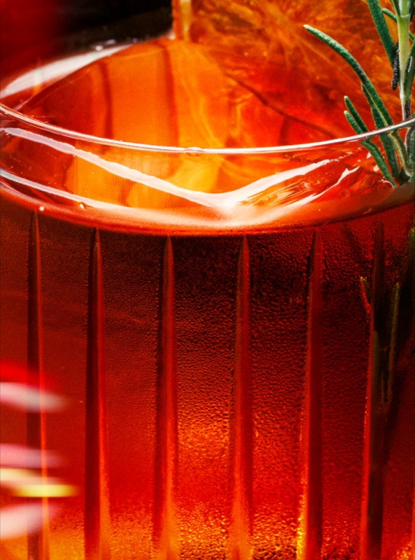 Negroni with a smoking rosemary sprig on a bar counter, shot for Music Bar Nightfly