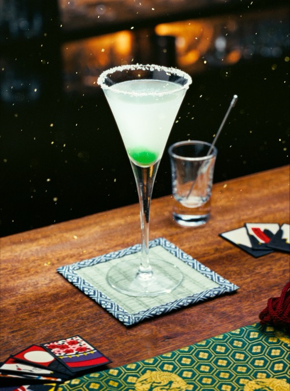 Yukiguni cocktail with a sugared rim beside hanafuda cards, shot for Music Bar Nightfly